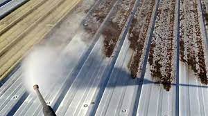 Pressure Washing a Metal Roof Pressure washing a metal roof is a great way to restore its appearance and remove dirt, grime, and other debris that can accumulate over time. However, it's important to use the right equipment and techniques to avoid damaging the roof or causing injury. In this article, we'll go over the steps involved in pressure washing a metal roof safely and effectively. Choose the Right Pressure Washer The first step in pressure washing a metal roof is to choose the right pressure washer. You'll want a pressure washer that's powerful enough to remove dirt and grime, but not so powerful that it damages the roof. Ideally, you should use a pressure washer with a maximum pressure of around 1500 psi and a flow rate of around 1.5 gallons per minute. You should also use a pressure washer with a spray nozzle that can adjust the pressure to a lower setting. Gather Your Materials In addition to a pressure washer, you'll need a few other materials to pressure wash your metal roof. These include: Safety equipment: Eye protection, ear protection, and non-slip shoes are essential safety equipment when pressure washing a roof. Cleaning solution: You can use a commercial metal roof cleaner or a mixture of water and mild detergent to clean your metal roof. Ladder: You'll need a sturdy ladder to climb onto the roof and to move around while pressure washing. Garden hose: You'll need a garden hose to rinse the roof after pressure washing. Soft-bristled brush: A soft-bristled brush can be helpful for removing stubborn stains or debris. Prepare the Roof Before you begin pressure washing, you'll need to prepare the roof. This includes removing any debris, such as branches or leaves, from the roof. You should also trim any nearby trees or bushes to prevent them from scratching the roof or obstructing your view while pressure washing. Finally, you should cover any nearby plants or landscaping with plastic sheeting to protect them from the cleaning solution. Apply the Cleaning Solution Once the roof is prepared, it's time to apply the cleaning solution. You can do this by using a pump sprayer or a garden sprayer to apply the solution evenly over the roof. Make sure to cover the entire roof with the cleaning solution, including the gutters and any other metal surfaces. Allow the cleaning solution to sit for a few minutes to loosen dirt and grime. Pressure Wash the Roof After the cleaning solution has had time to work, it's time to pressure wash the roof. Start by standing on the ladder and using the pressure washer to spray water onto the roof at a low pressure. Work in sections, starting at the top of the roof and working your way down. Keep the pressure washer at a safe distance from the roof, at least 6 inches, to avoid causing damage. Rinse the Roof Once you've pressure washed the entire roof, it's time to rinse it off. Use a garden hose to rinse the roof with clean water, starting at the top and working your way down. Make sure to rinse off all the cleaning solution and any remaining dirt or debris. Take care not to spray water into the roof vents or any other openings. Inspect the Roof After rinsing the roof, take the time to inspect it for any damage or areas that may need repair. Look for any dents, scratches, or rust spots that may have been hidden by the dirt and grime. If you notice any damage, consider calling a professional to make repairs. In conclusion, pressure washing a metal roof can be an effective way to restore its appearance and remove dirt and grime. However, it's important to use the right equipment and techniques to avoid causing damage to the roof or causing injury.